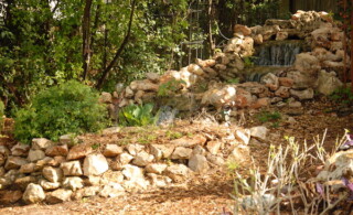 Backyard waterfall on stones