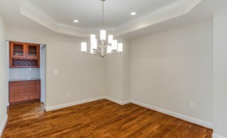 Empty room with white tray ceiling
