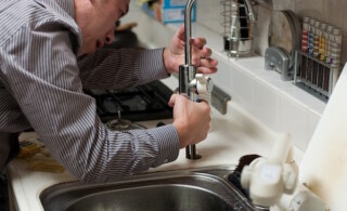 Plumber working on a faucet