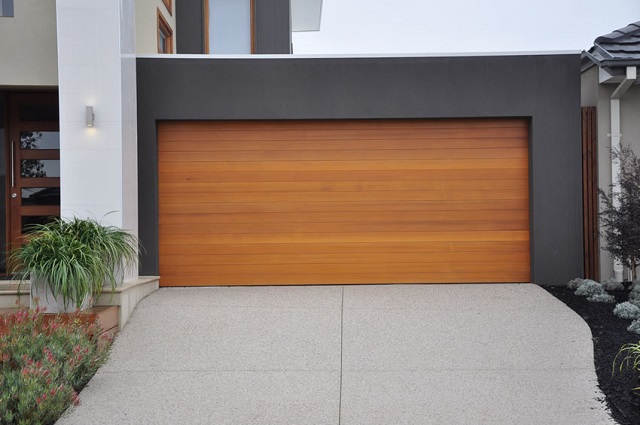 Modern, natural garage door in geometric, color block house