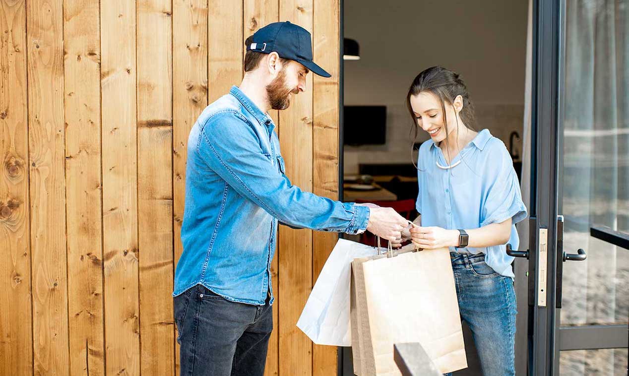 Errand service person bringing bags in to client