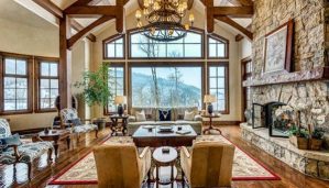 A rustic living room with a view of the Colorado mountains.