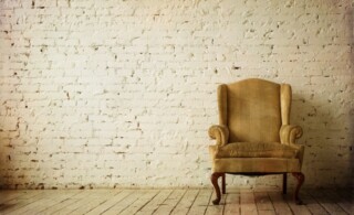 Old Retro Armchair against Blank White Wall
