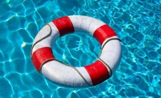 Safety life buoy in blue swimming pool