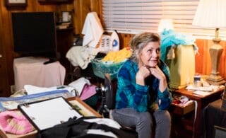 Senior woman at home in a messy room
