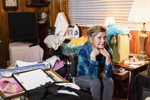 Senior woman at home in a messy room