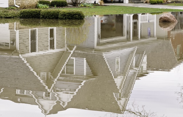 Reflection of suburban home in stormwater flood
