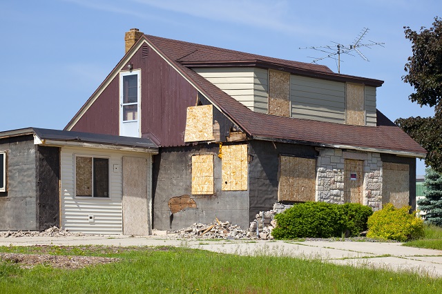 Damaged Destroyed Boarded-Up Abandoned House