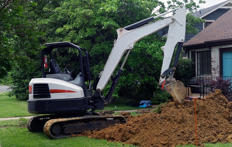 excavator in a front yard
