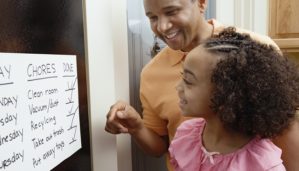 parent and child look at completed chores list
