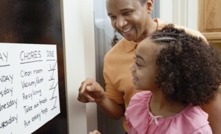 parent and child look at completed chores list