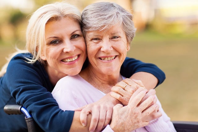 daughter embracing mother with alzheimers