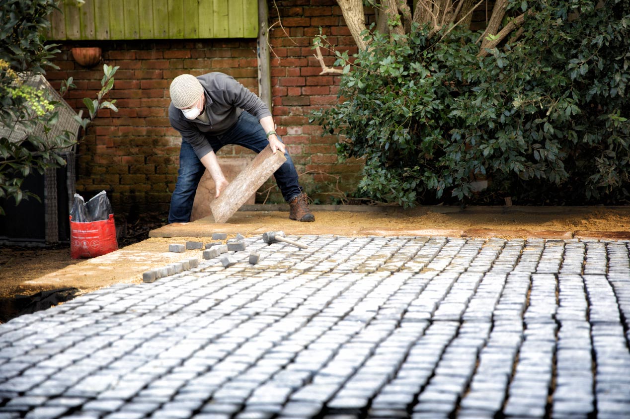 A man installing pavers 