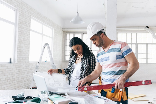 Woman managing home remodel with professional