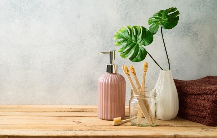 bamboo toothbrush on green eco-friendly bathroom countertop