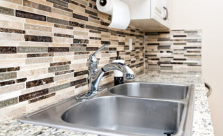 stainless steel sink in kitchen with backsplash
