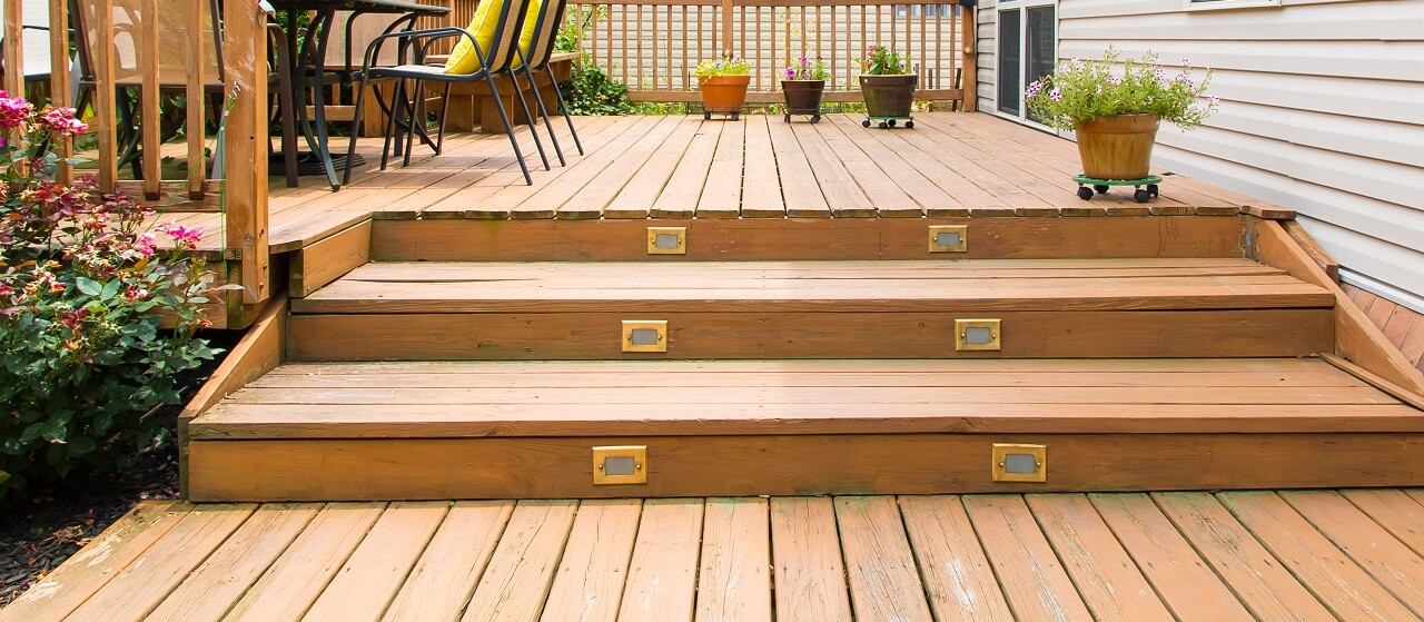 close-up of wood deck with steps and patio furniture