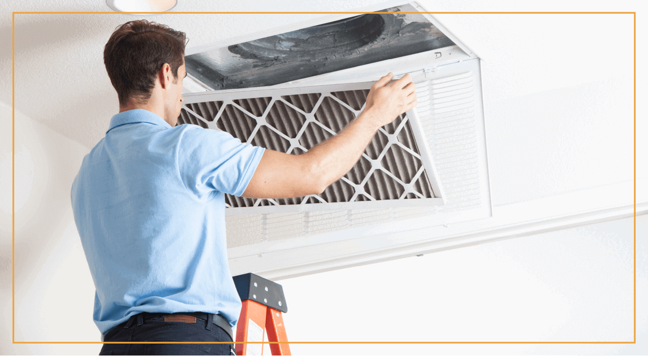 HVAC professional cleans air filters in a house