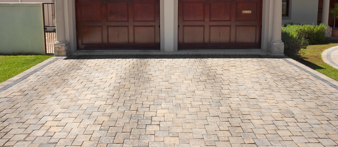 stone driveway in front of double garage
