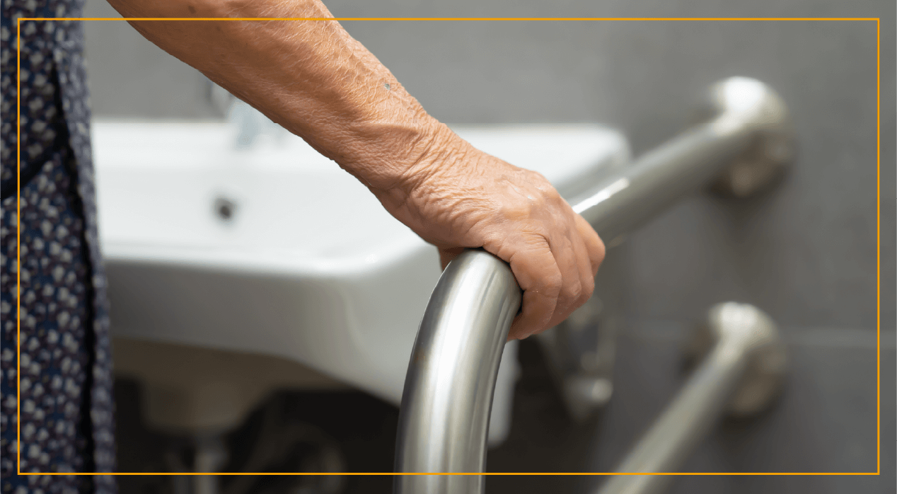 Woman using handrail by sink