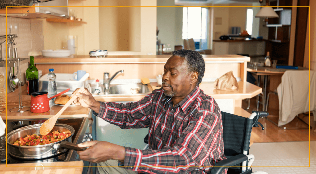 Man in wheelchair making food at stove