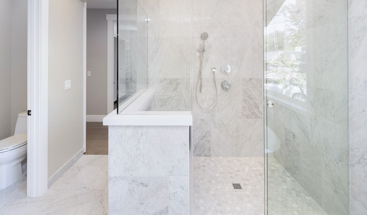 white bathroom with tile shower floor
