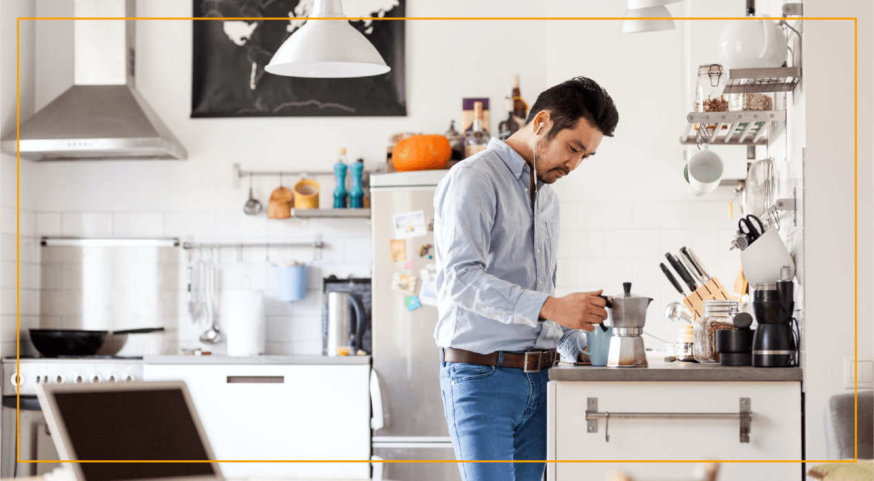 Man in kitchen pouring coffee out of French press