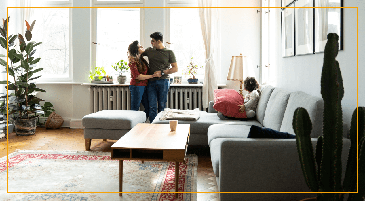 Young couple hugging in living room