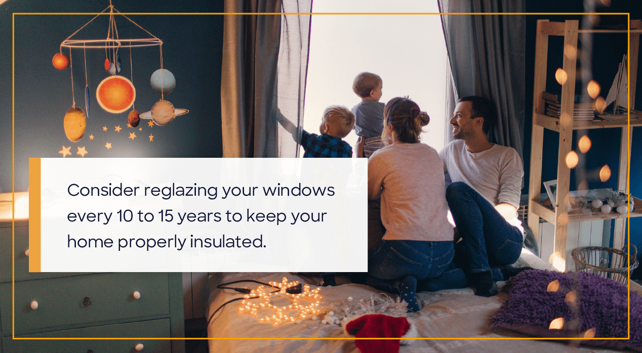 A man and woman with two little kids looking out a window