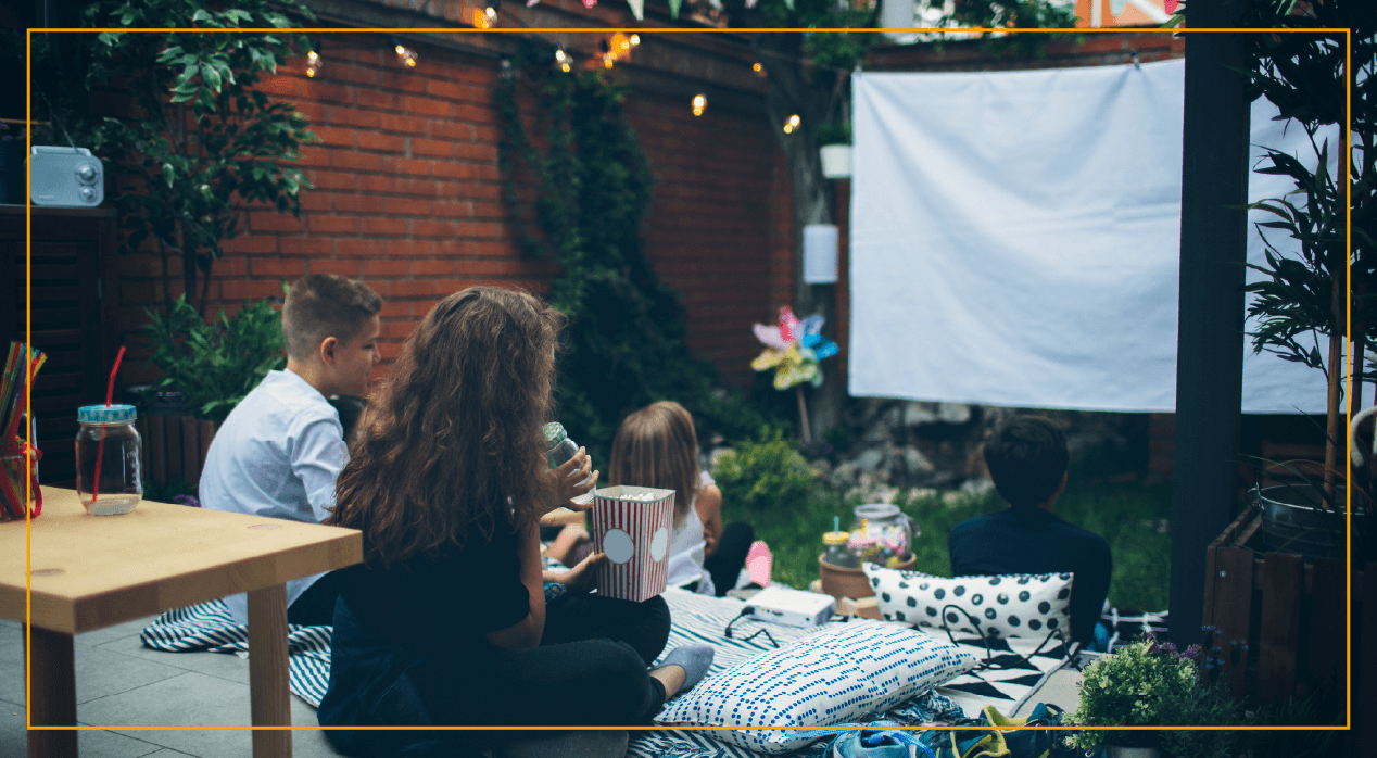 Family watching movie in custom backyard home movie theater