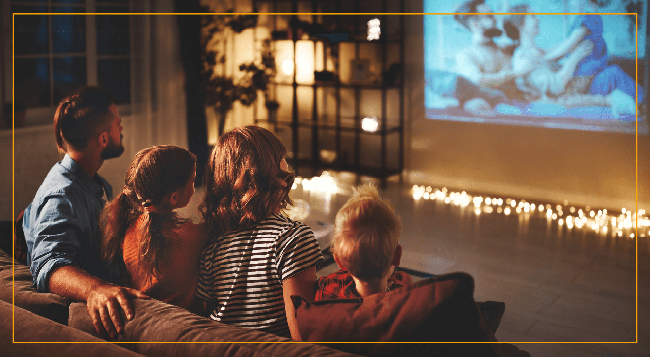 family watching projector screen