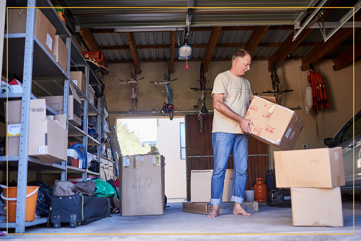 man in garage lifting boxes