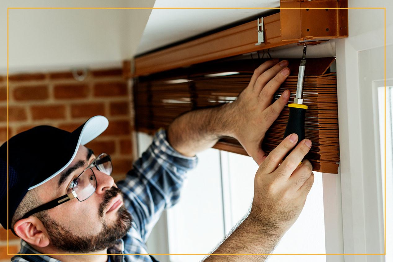 man installing blinds