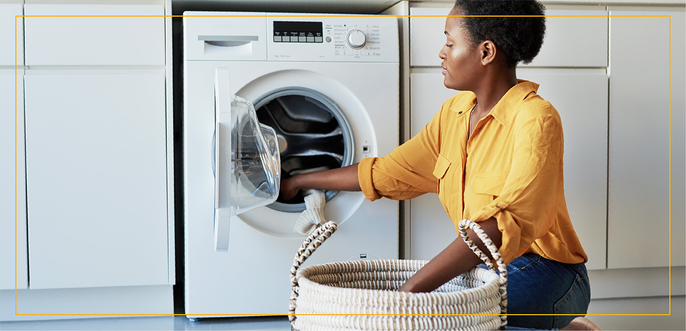 woman loading laundry into machine