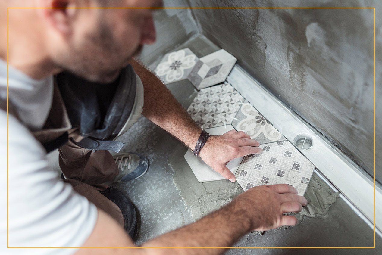 worker installing floor tile