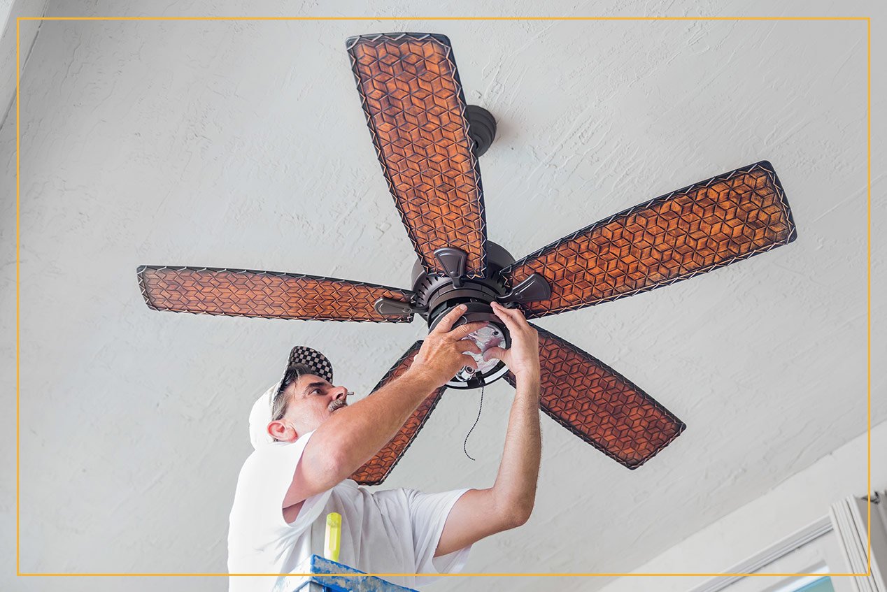 contractor installing ceiling fan