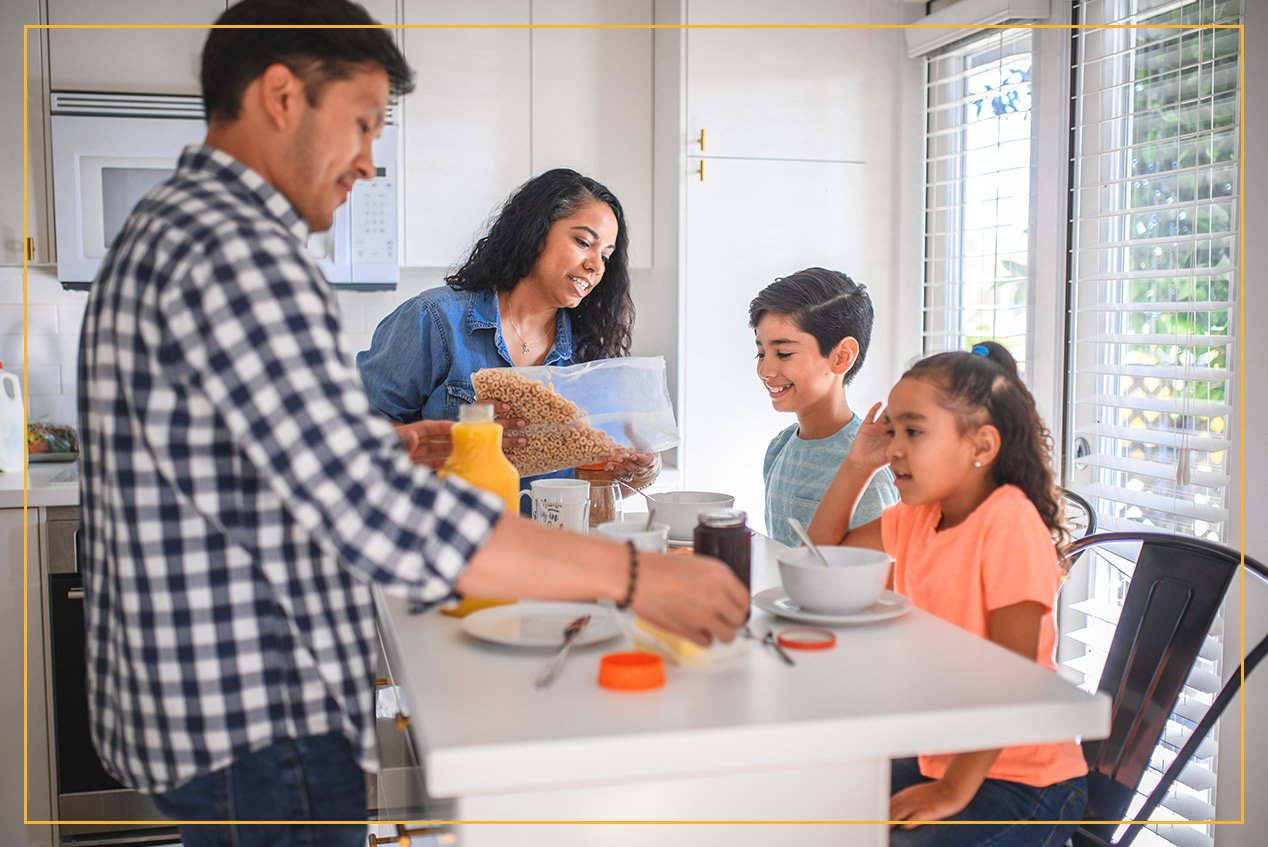 family eating breakfast at kitchen island