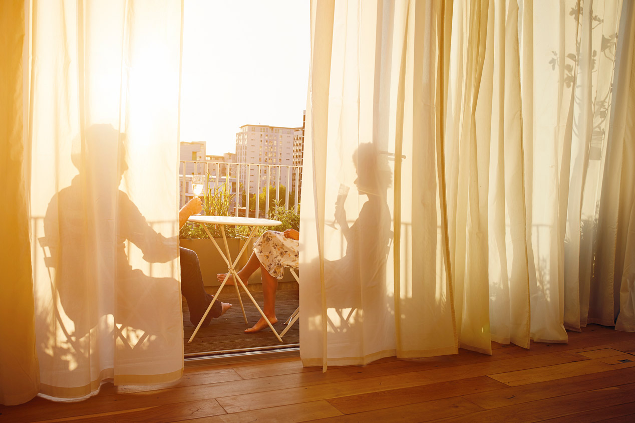 A couple spending quality time in their apartment’s balcony