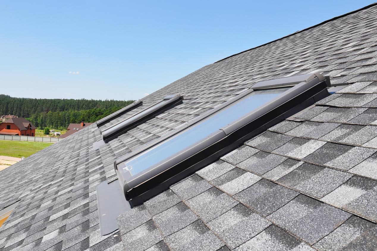 Skylight windows on a roof with luxury shingles