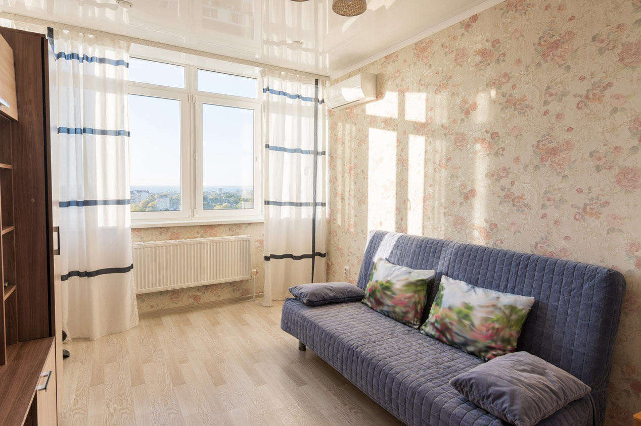 A small studio living room with laminate flooring