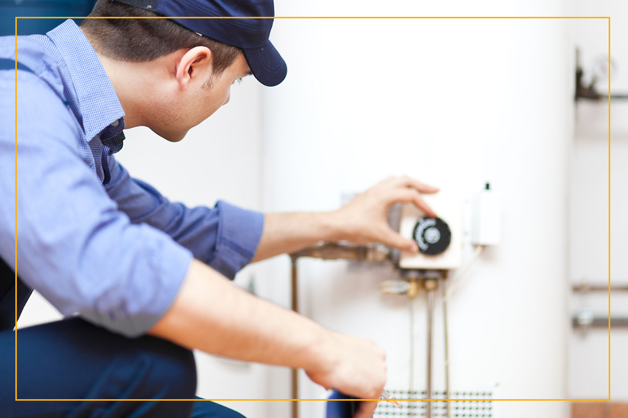 technician repairing hot water heater