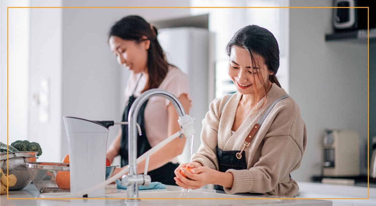 two women in kitchen making food