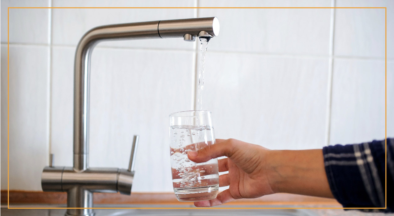 someone filling up glass with water from sink