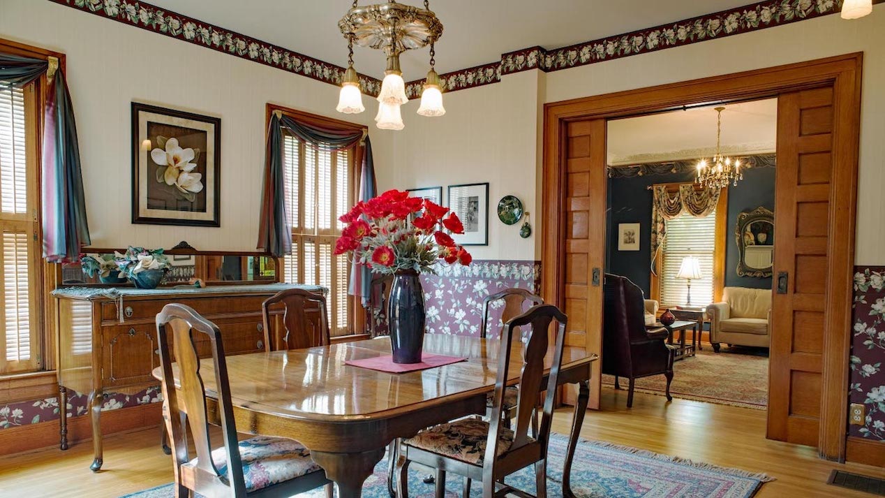 A victorian dining room with pocket doors