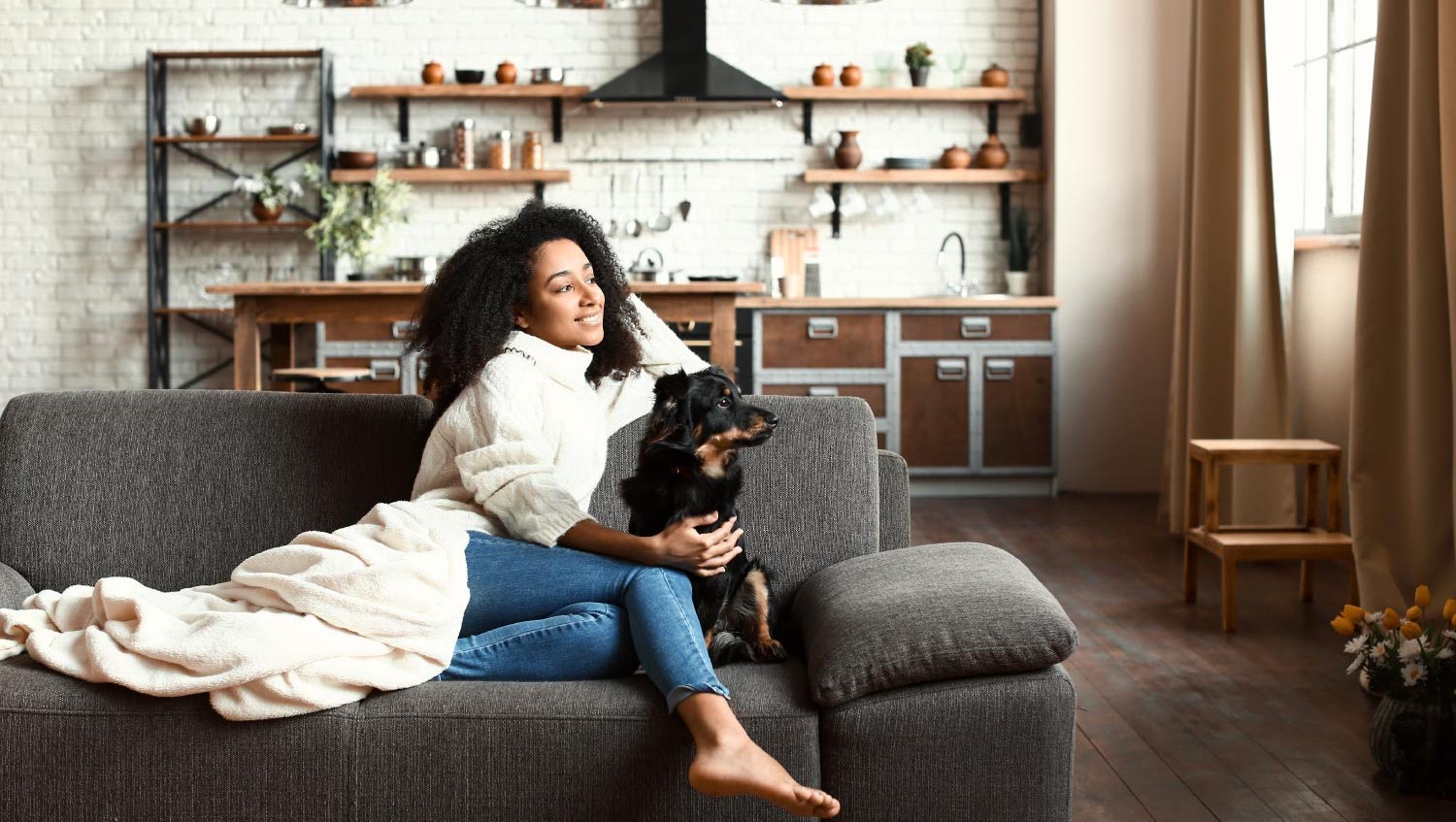 Woman sitting in the living room with her dog