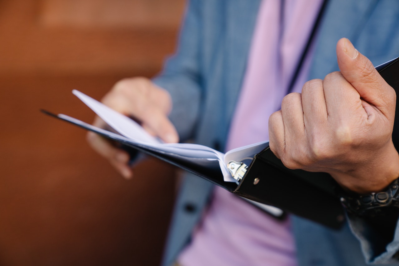 person holding a binder