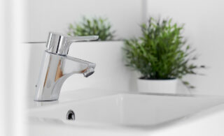 Close-up of a faucet and a basin in a bathroom