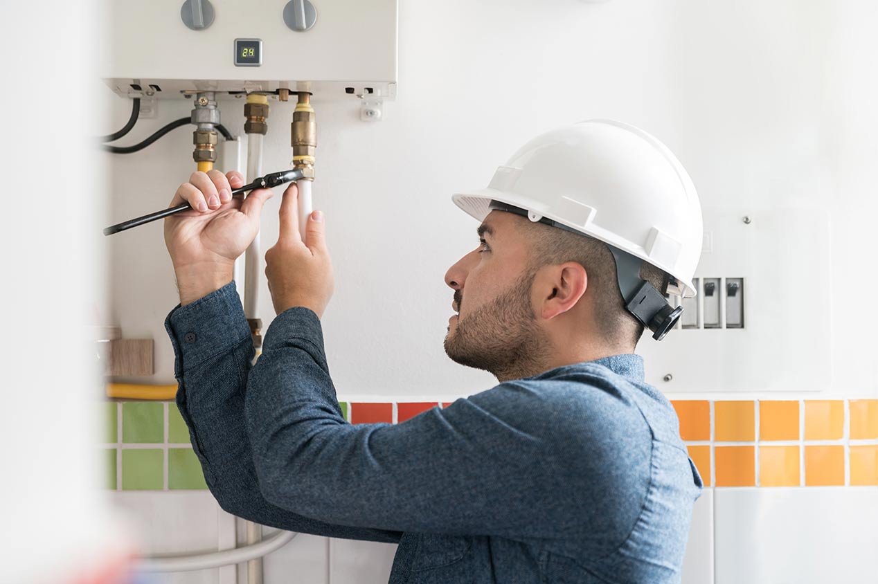 technician installing natural gas boiler